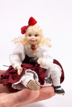 Load image into Gallery viewer, Little Girl Doll in Victorian Red & White Dress with Bow in Long Blonde Hair Sitting Down Pat Melvin Artisan Made