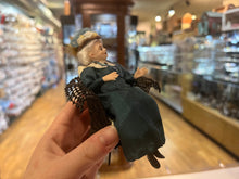 Load image into Gallery viewer, Dollhouse Miniatures ~ The London Supply Older Lady Doll in Green Dress Sitting in Brown Wicker Chair
