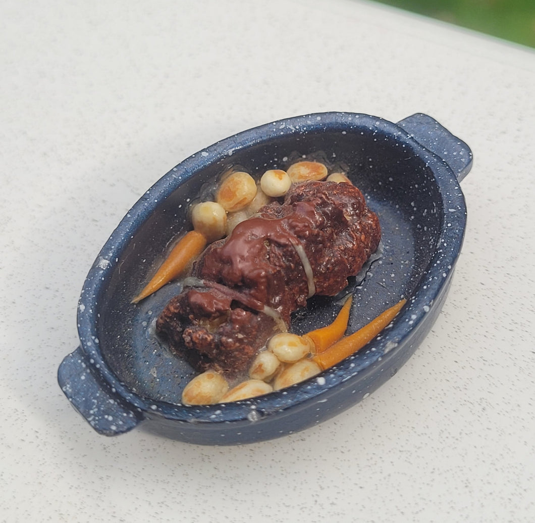 Duck roast in pan with carrots and potatoes