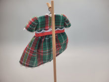 Load image into Gallery viewer, Green and Red Plaid Dress with Red Bow on Wooden Display – by Cheryl Warder
