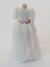 Load image into Gallery viewer, Handmade White Lacey Dress with Pink Ribbon on Mannequin
