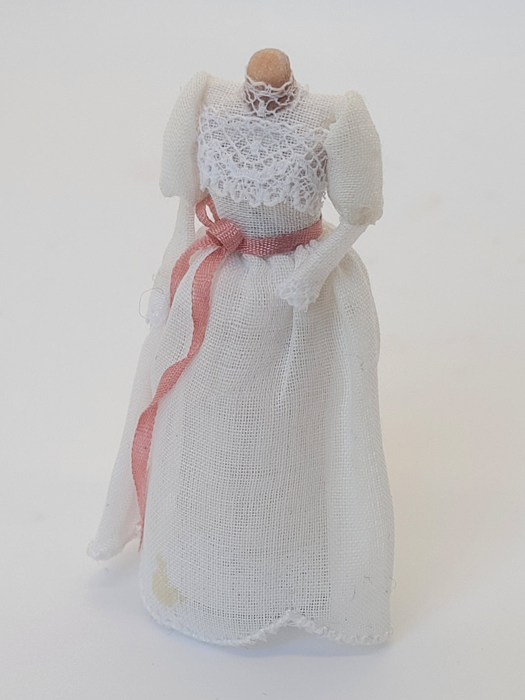 Handmade White Lacey Dress with Pink Ribbon on Mannequin