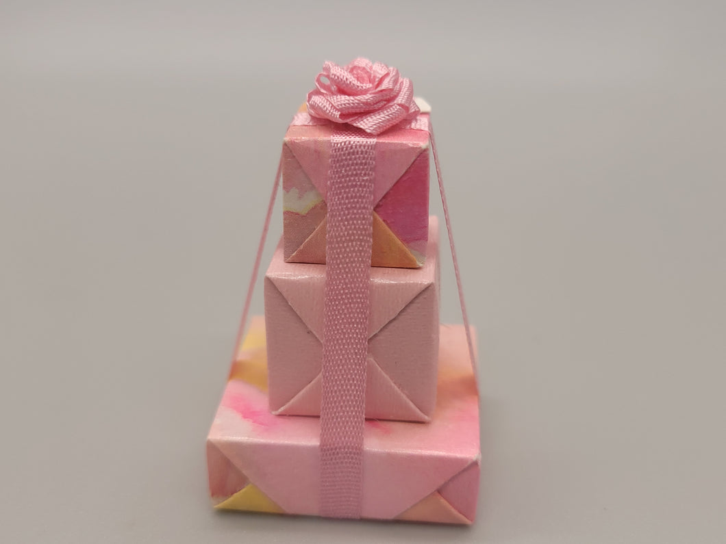 3 Tier Presents Wrapped in Pink and Yellow Paper with Pink Bow