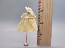 Load image into Gallery viewer, Yellow &amp; White Dress with Matching Hat on Wood Stand - by Cheryl Warder
