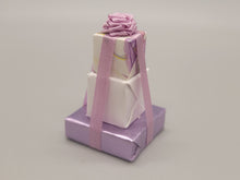 Load image into Gallery viewer, 3 Tier Presents Wrapped in Purple and White Paper with Purple Bow – By Cheryl Warder
