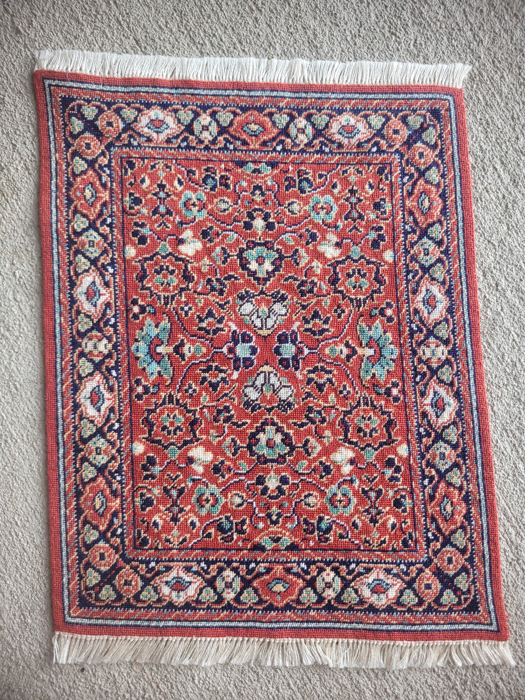 Dollhouse Miniature ~ Petit Point Persian-Inspired Rug with Red Ground, Navy Accents, and Detailed Border Work  - Ursula Sauerberg