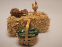 Load image into Gallery viewer, Haybale with Chicken and Cucumbers in Woven Basket
