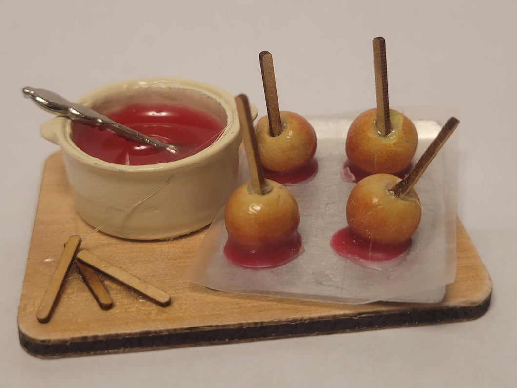 Candy Apples and Pot on Wooden Board