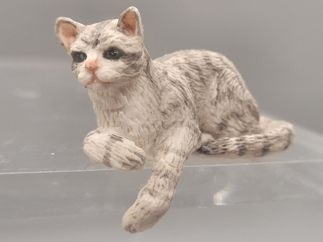 Resin Grey Striped Cat Laying with Paw Hanging