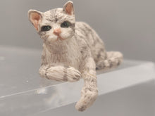 Load image into Gallery viewer, Resin Grey Striped Cat Laying with Paw Hanging
