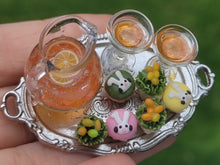 Load image into Gallery viewer, Easter Cupcakes with Orange Drink on Platter

