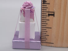Load image into Gallery viewer, 3 Tier Presents Wrapped in Purple and White Paper with Purple Bow – By Cheryl Warder
