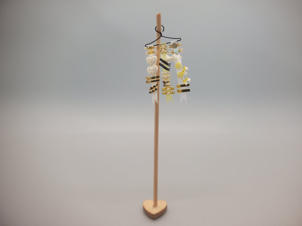 Yellow Ribbons and Barrettes for a Little Girl on Wooden Stand - by Cheryl Warder